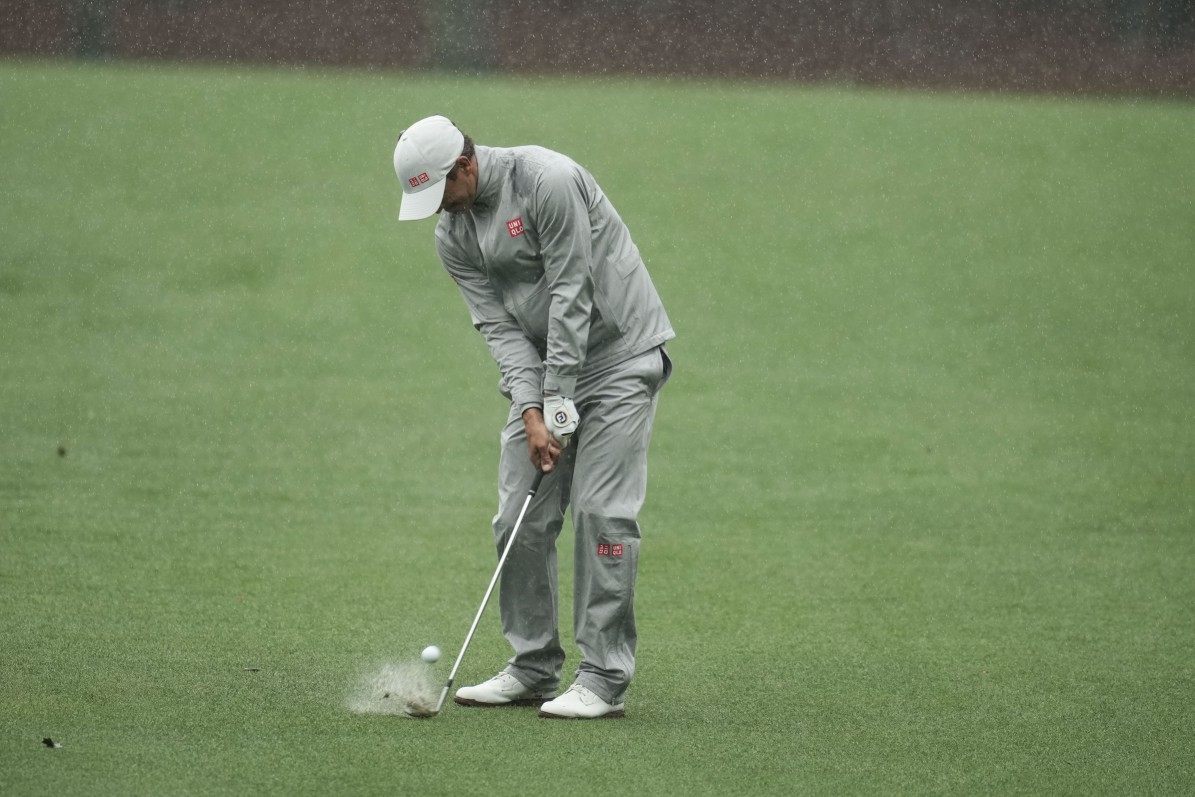 Adam Scott, of Australia, hits from the fairway on the 13th hole during the weather delayed third round of the Masters golf tournament at Augusta National Golf Club on Saturday, April 8, 2023, in Augusta, Ga. (AP Photo/Mark Baker)