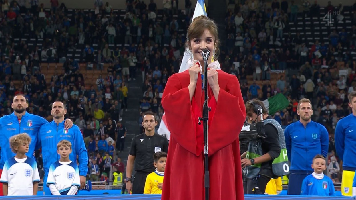 Carly Paoli, , National anthem singer for England clash STRIPS OFF red cloak to reveal full Italy kit, , 23rd September 2022, , Channel 4