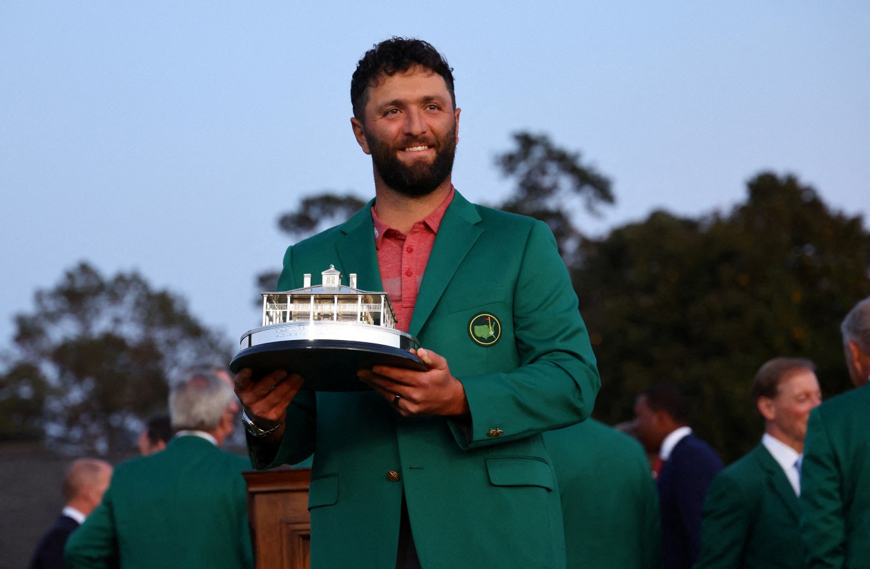 FILE PHOTO: Golf - The Masters - Augusta National Golf Club - Augusta, Georgia, U.S. - April 9, 2023 Spain's Jon Rahm celebrates with his green jacket and the trophy after winning The Masters REUTERS/Mike Segar/File Photo