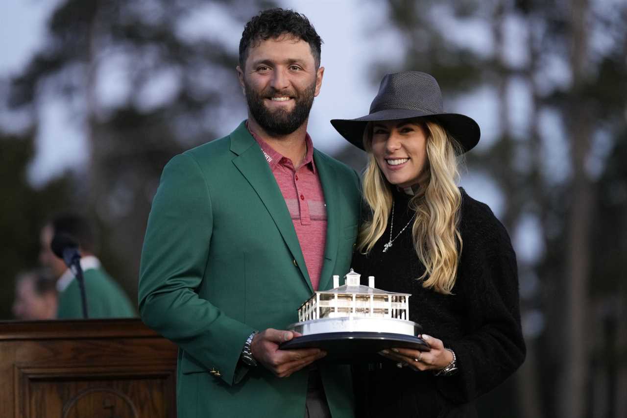 Jon Rahm, of Spain, holds the trophy with his wife Kelley Cahill after Rahm won the final round of the Masters golf tournament at Augusta National Golf Club on Sunday, April 9, 2023, in Augusta, Ga. (AP Photo/David J. Phillip)