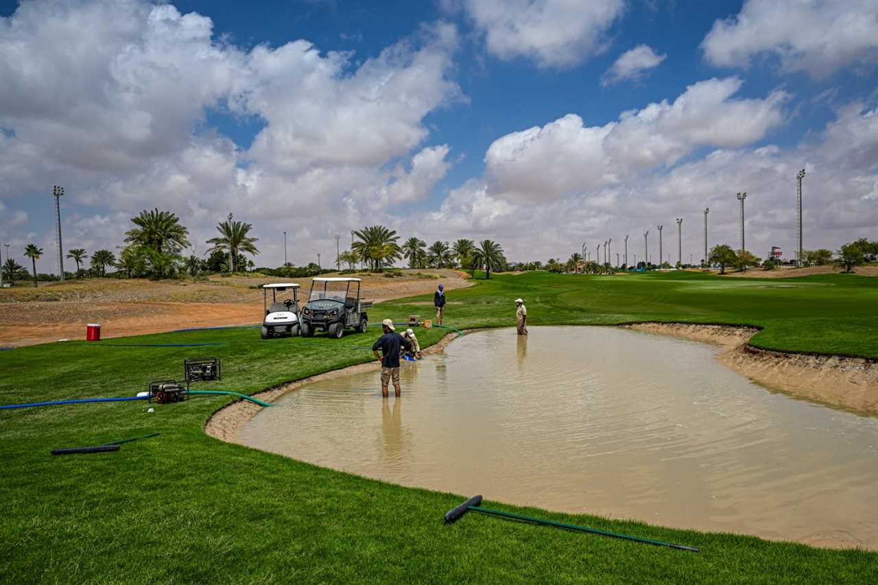 ABU DHABI, UNITED ARAB EMIRATES - APRIL 17: Grounds Staff drain water from the flooded bunker area on the course prior to the Abu Dhabi Challenge at Al Ain Equestrian, Shooting and Golf Club on April 17, 2024 in Abu Dhabi, United Arab Emirates. (Photo by Octavio Passos/Getty Images)
