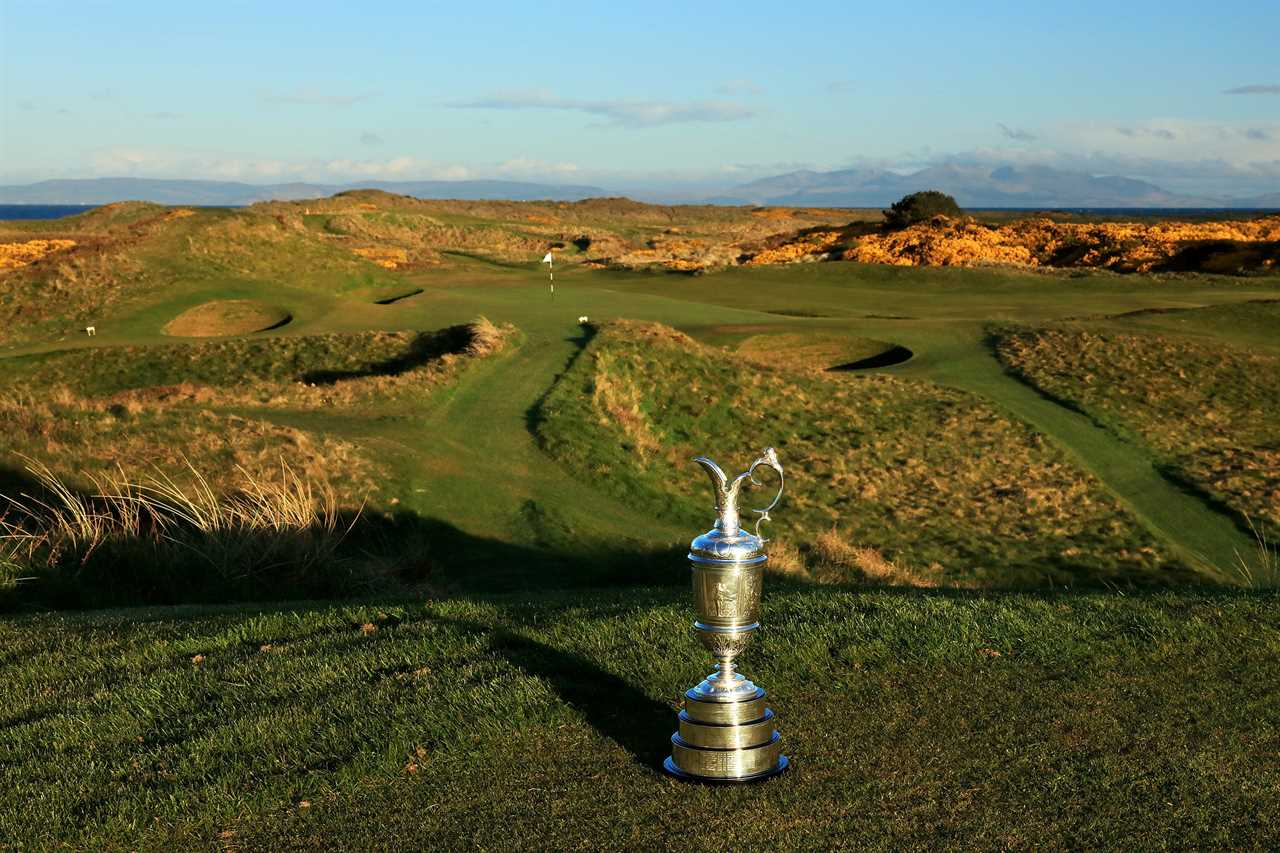 a golf course with a trophy in the foreground