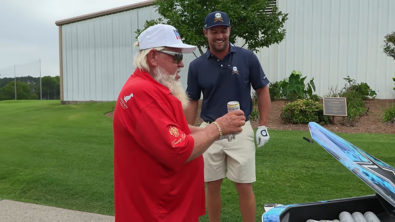 a man in a red shirt that says ' golf ' on it