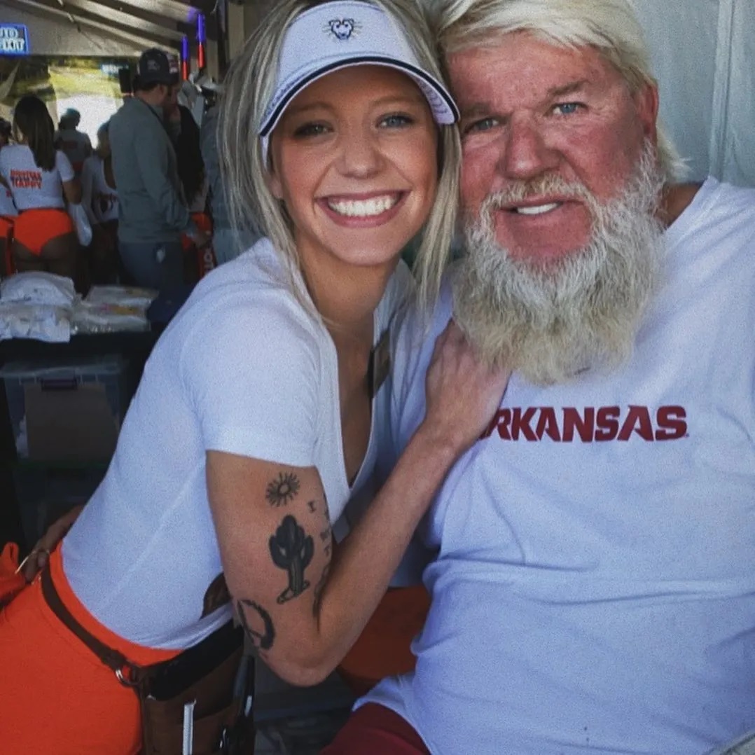 a man with a beard is wearing a arkansas shirt