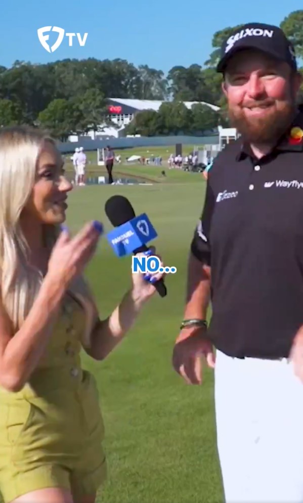 a woman holding a microphone with the word no on it