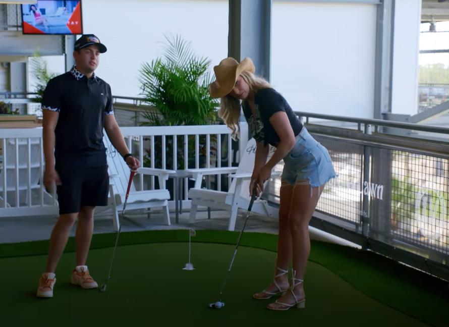 a man and a woman are playing a game of golf