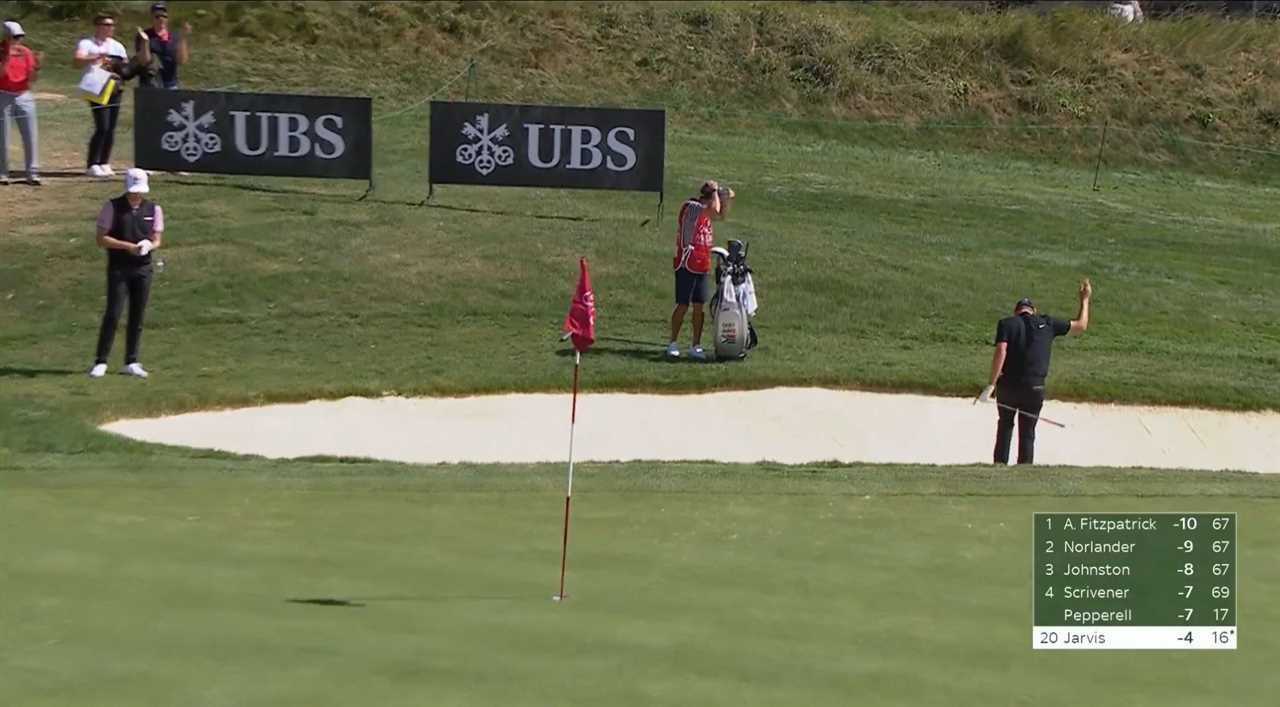 a golf course with a ubs banner in the background