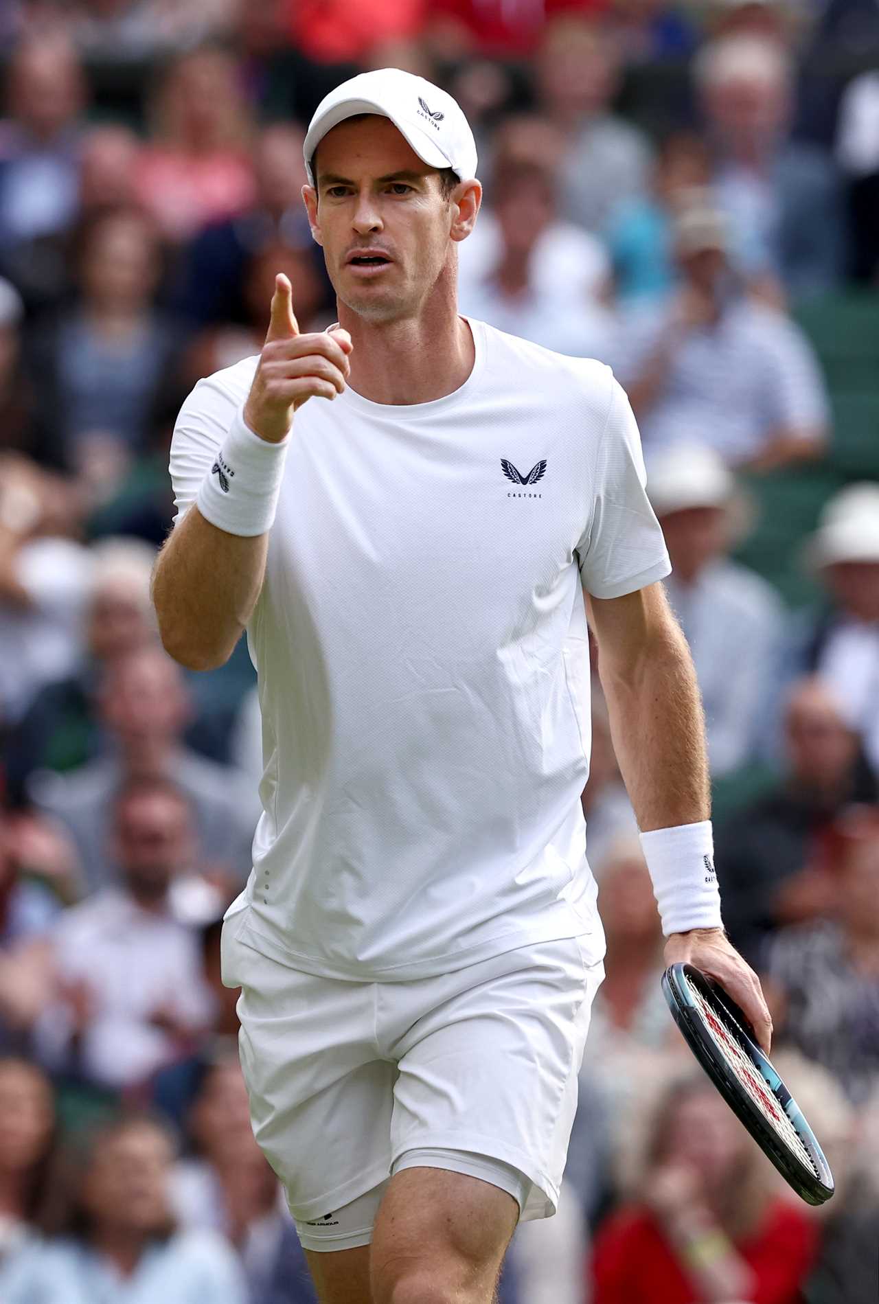 a tennis player wearing a white shirt with a butterfly on it