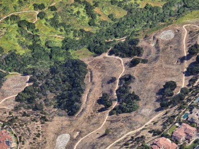 an aerial view of a residential area with houses and trees