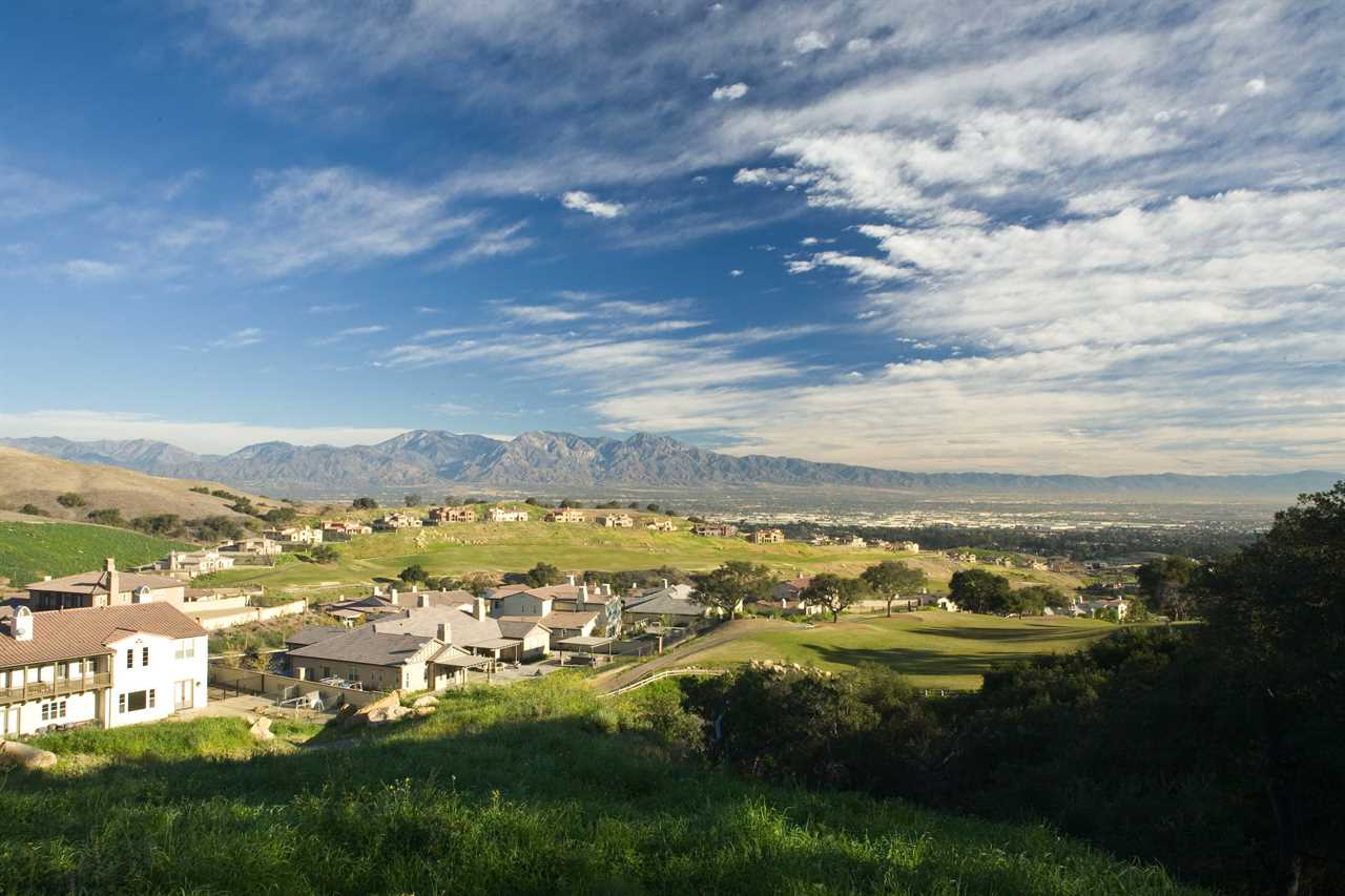 a view of a residential area with mountains in the background