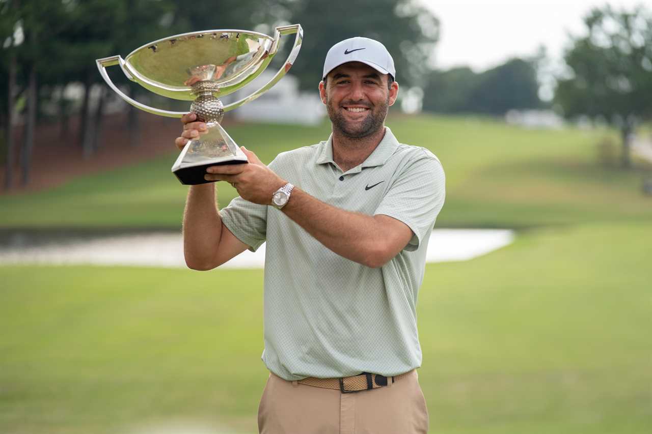 a man wearing a nike hat is holding a trophy