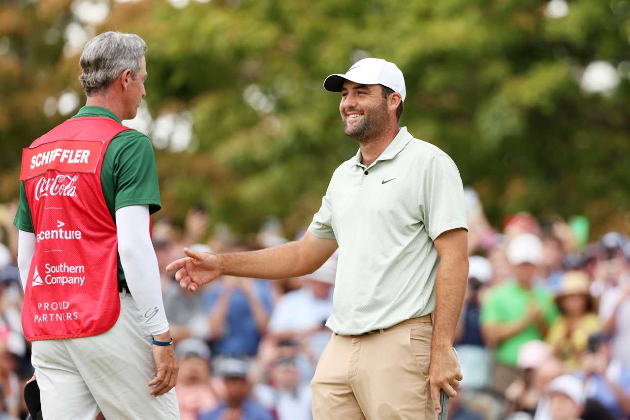 a man wearing a coca cola shirt shakes hands with another man