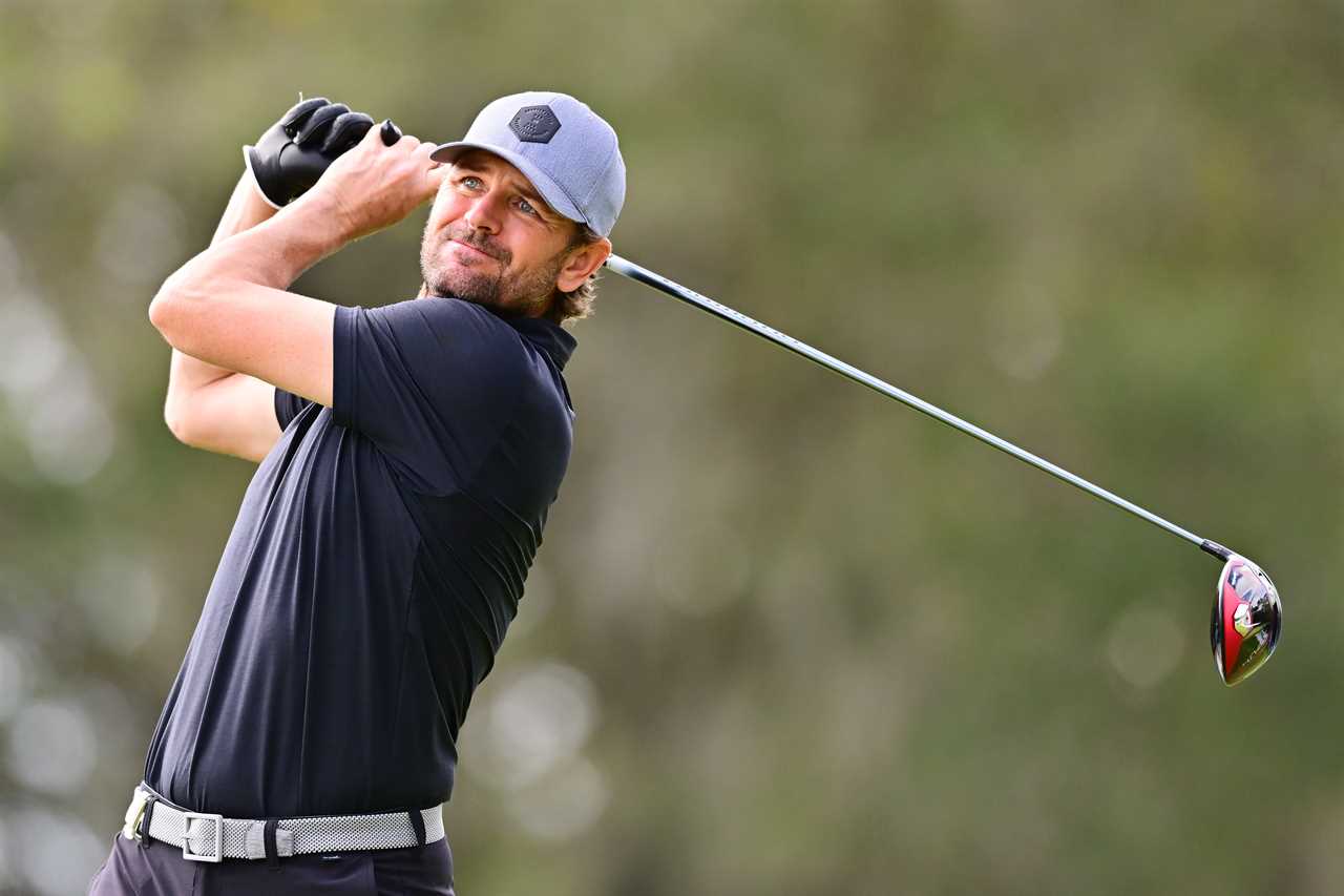 a man swings a golf club on a golf course