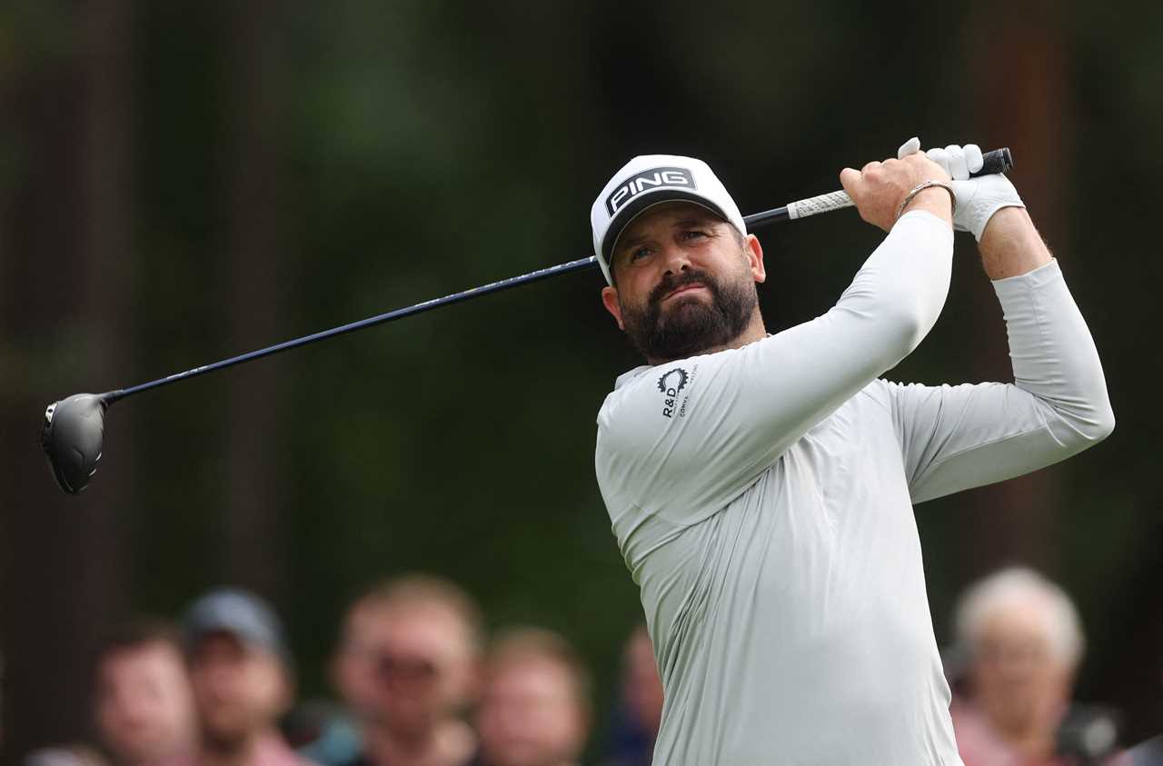 a man wearing a ping hat is swinging a golf club