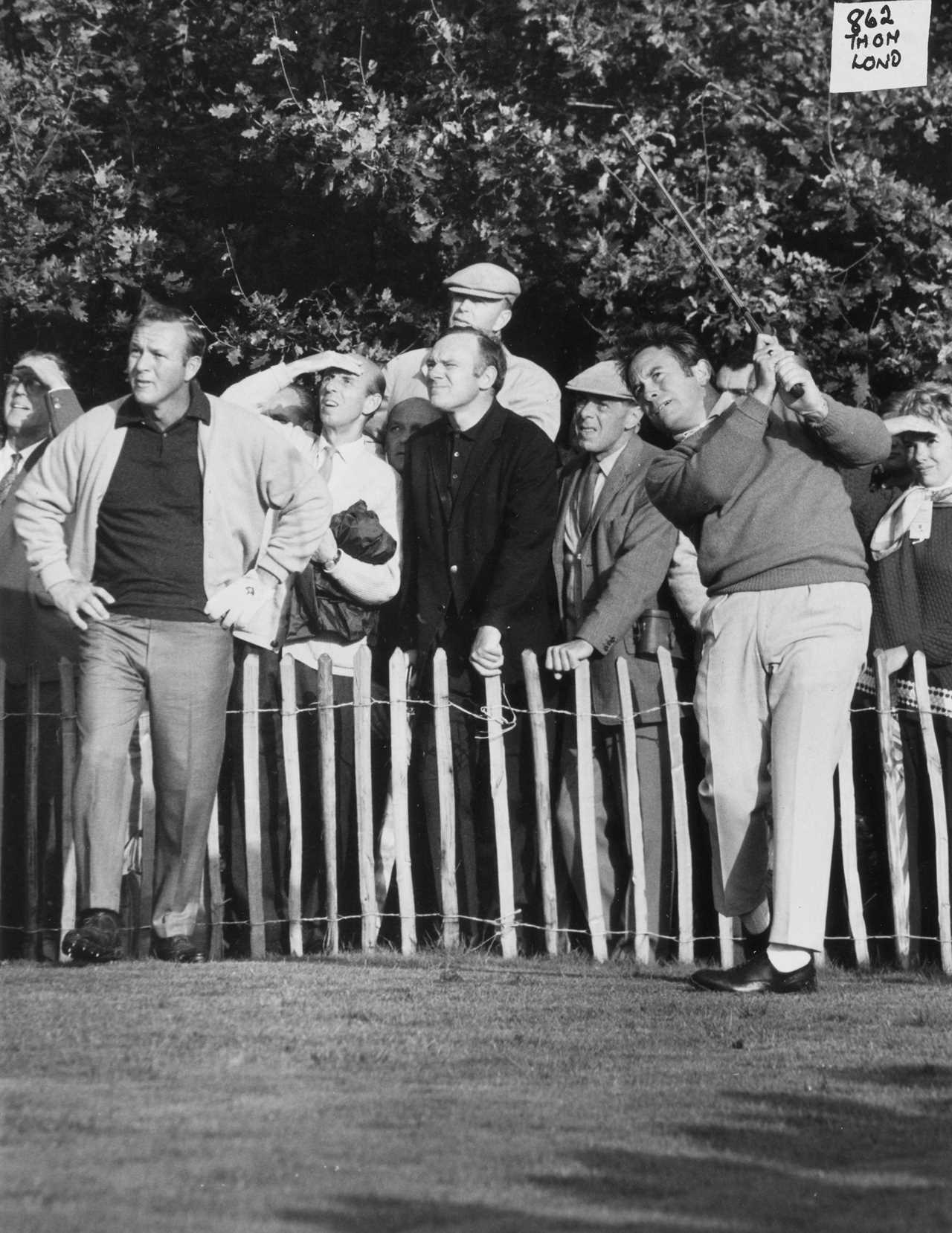 a black and white photo of a man swinging a golf club with a sign that says 962 very loud