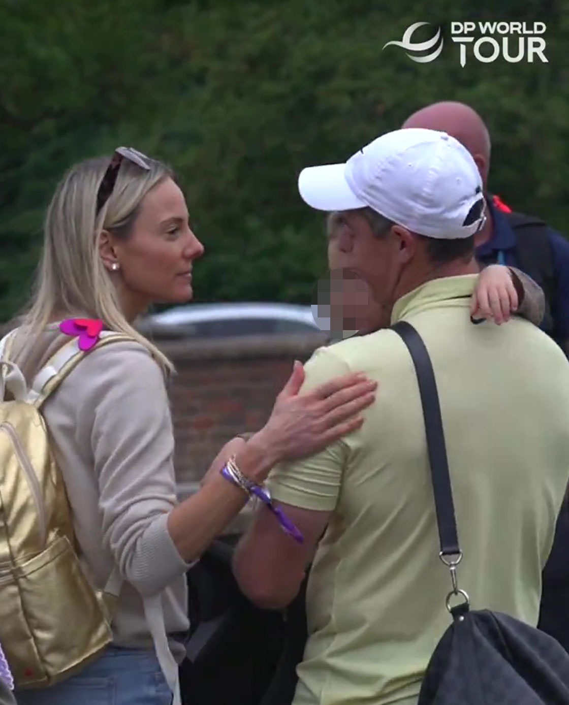 a man in a white hat is talking to a woman with a gold backpack