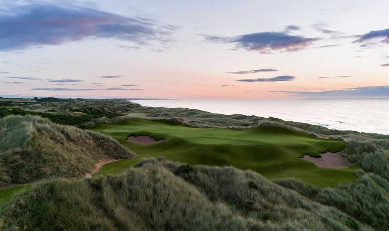 an aerial view of a golf course with the ocean in the background