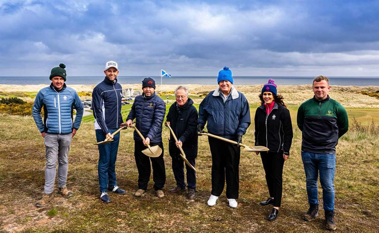 a group of people standing on top of a hill with one wearing a rolex sweatshirt