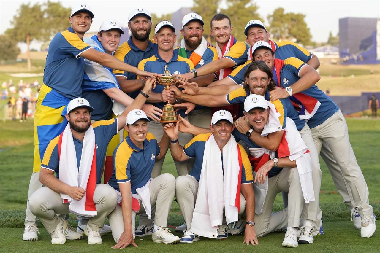 a group of men holding a trophy with the letter r on their hats