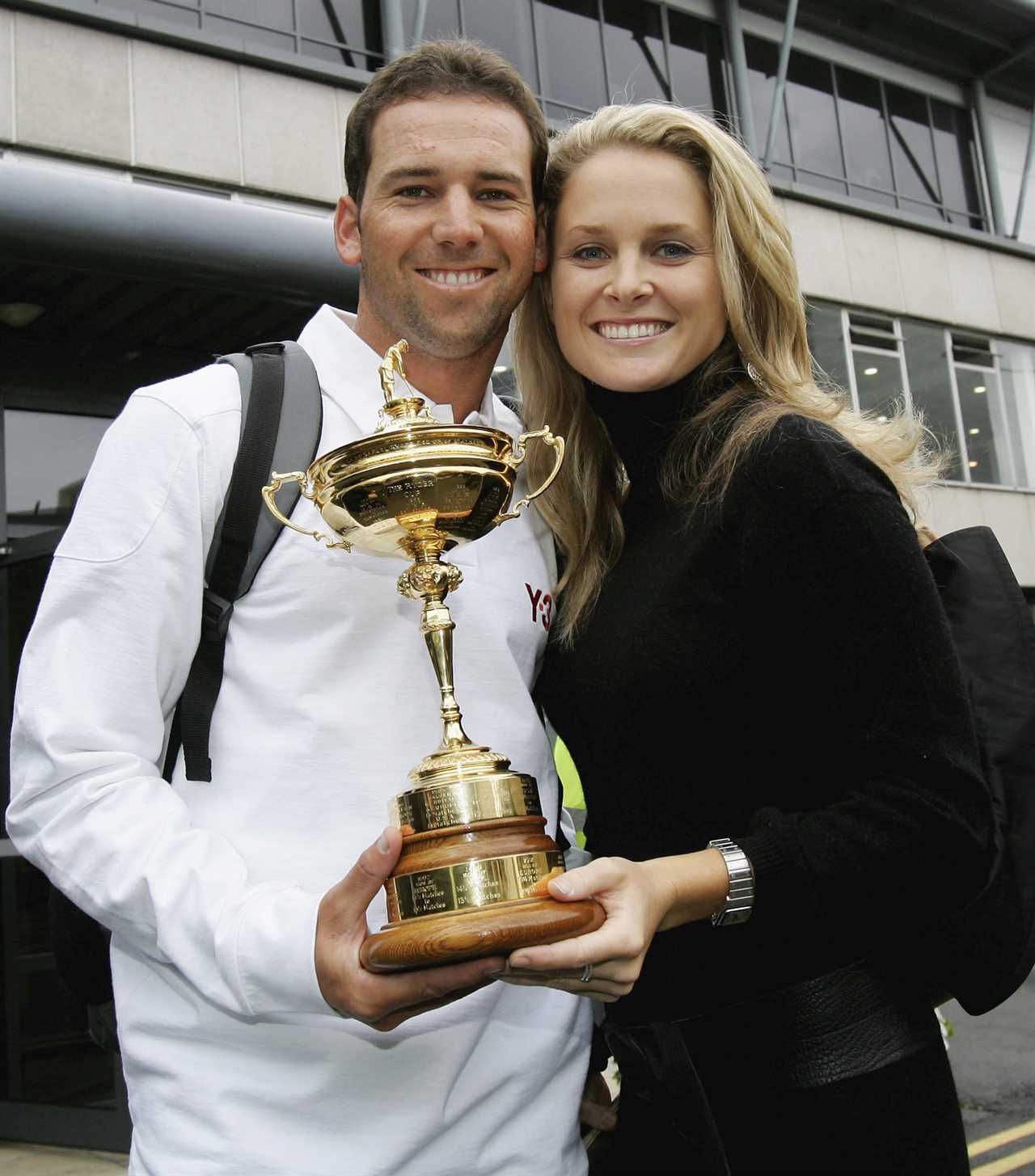 a man and a woman holding a trophy that says yo on it