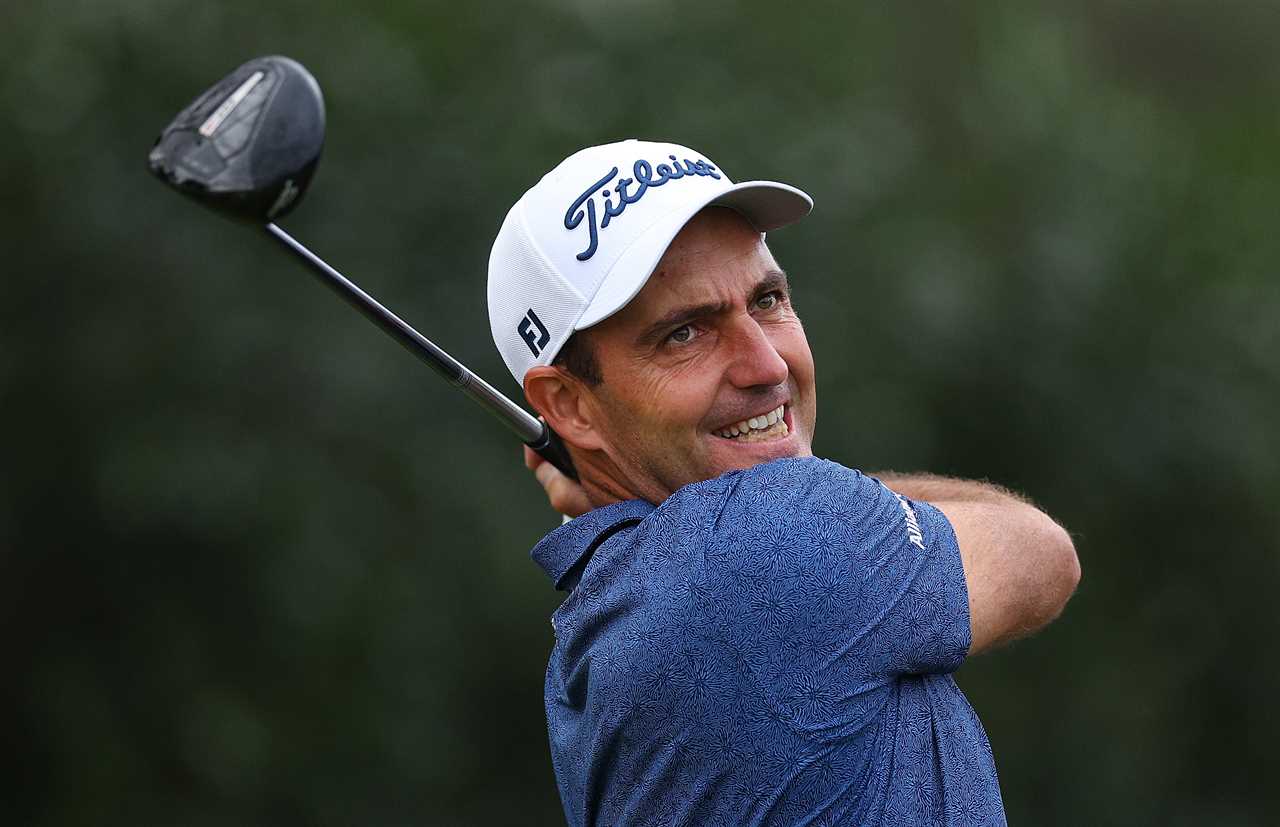 a man wearing a titleist hat is swinging a golf club