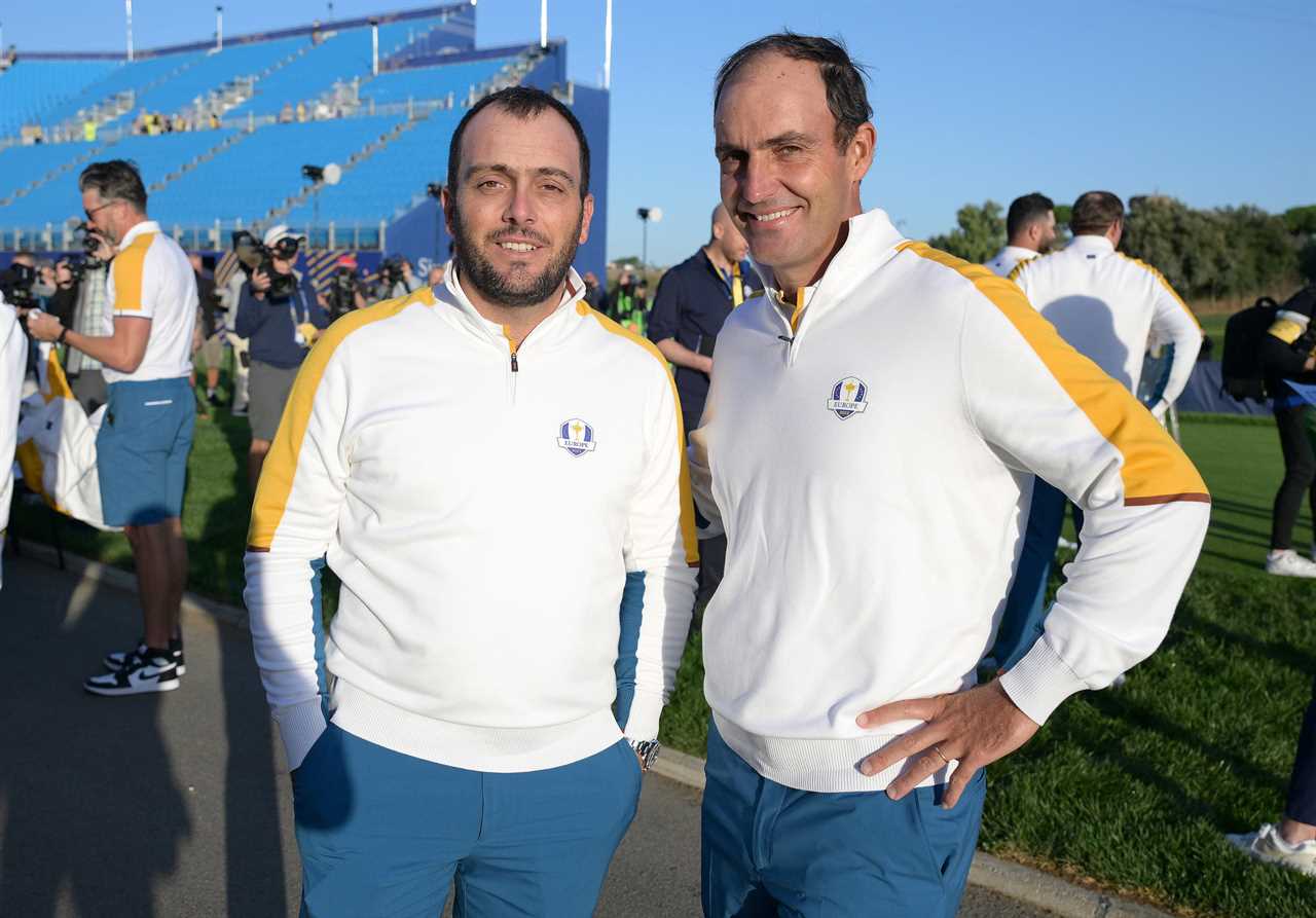 two men standing next to each other wearing polo shirts