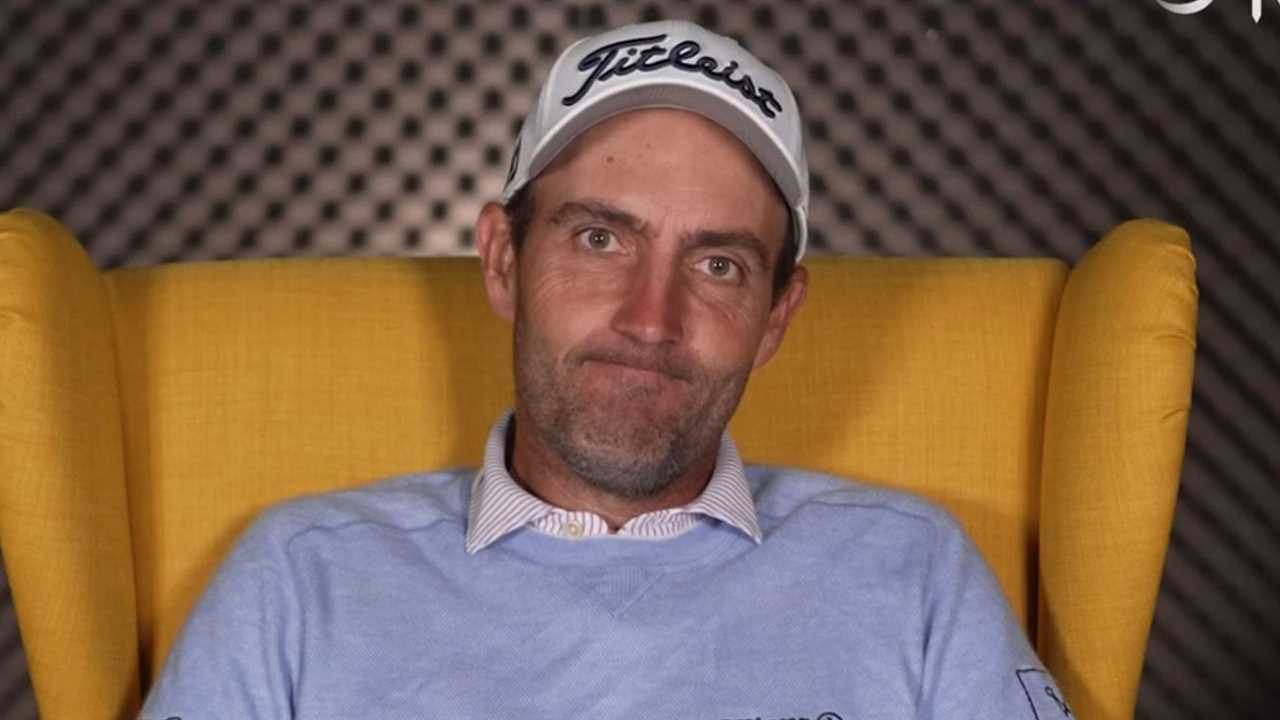 a man wearing a hat that says titleist on it