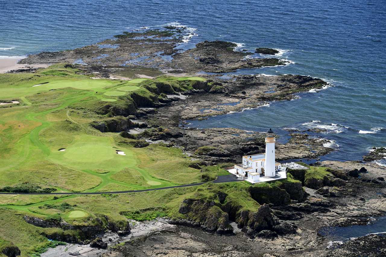 an aerial view of a lighthouse and a golf course