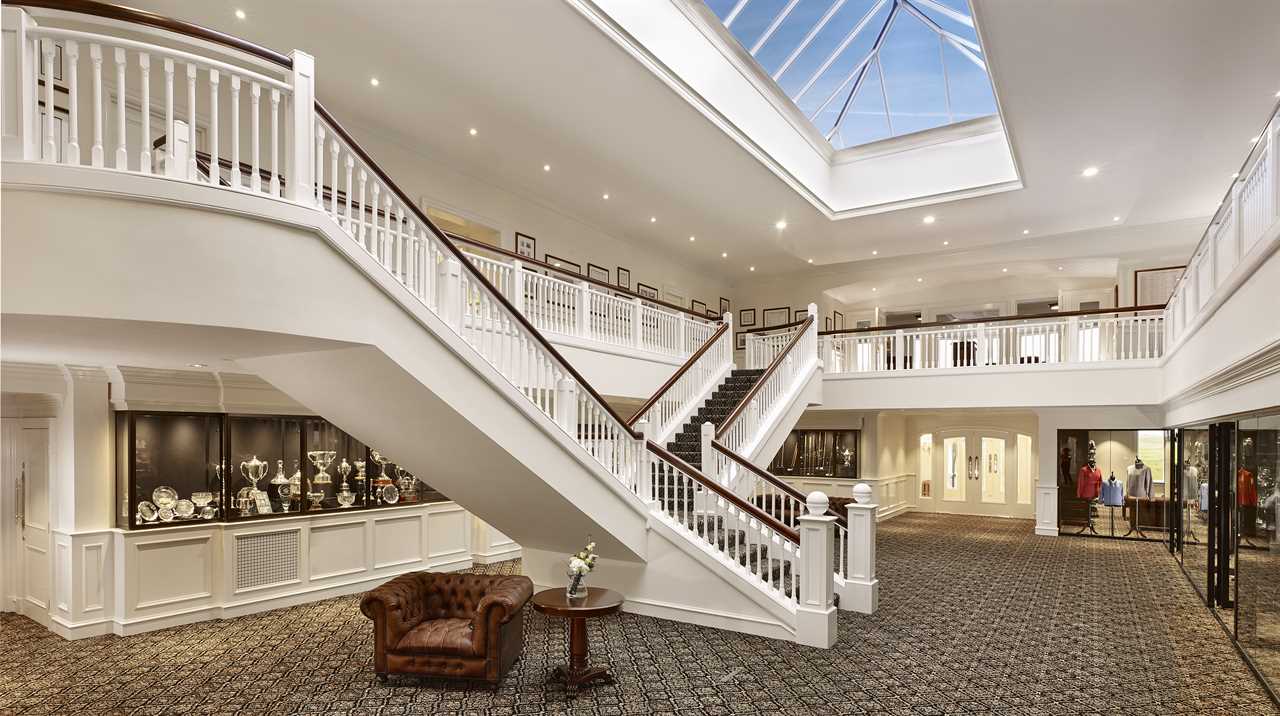 a staircase in a building with trophies on the wall