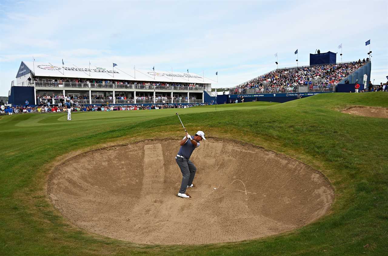 a golfer is hitting a ball out of a bunker