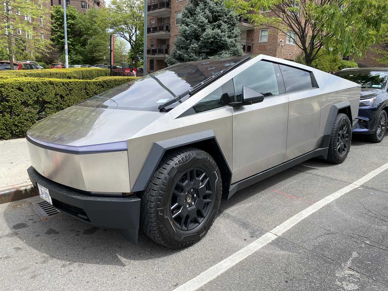 a silver tesla cybertruck is parked in a parking lot