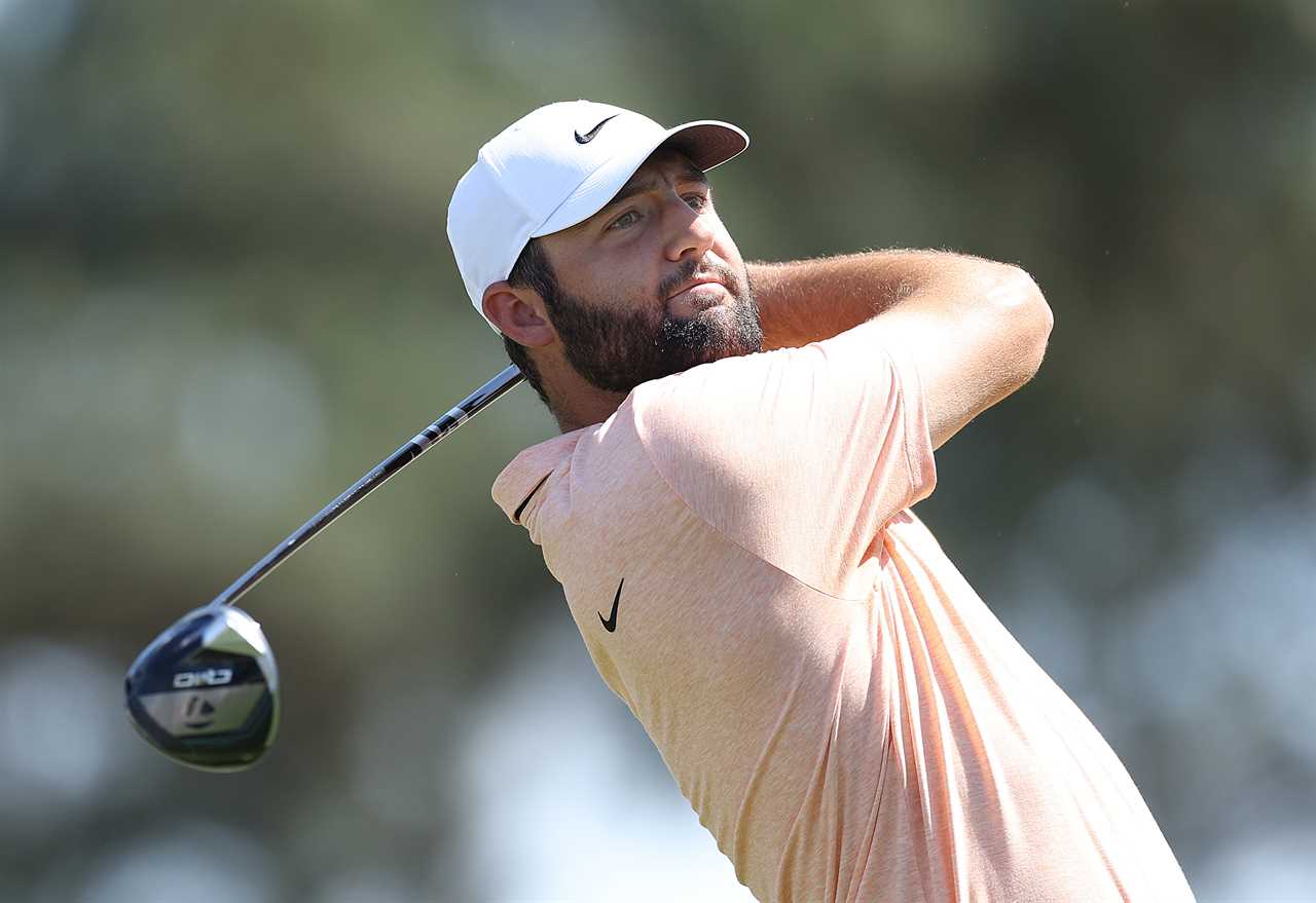 a man swinging a golf club on a golf course wearing a shirt that says nike