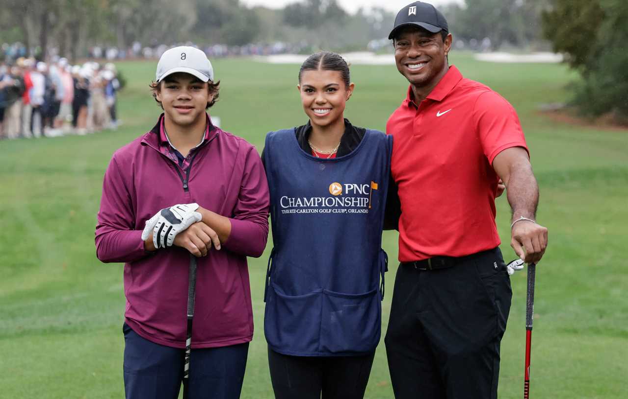 tiger woods and his son pose for a photo on a golf course