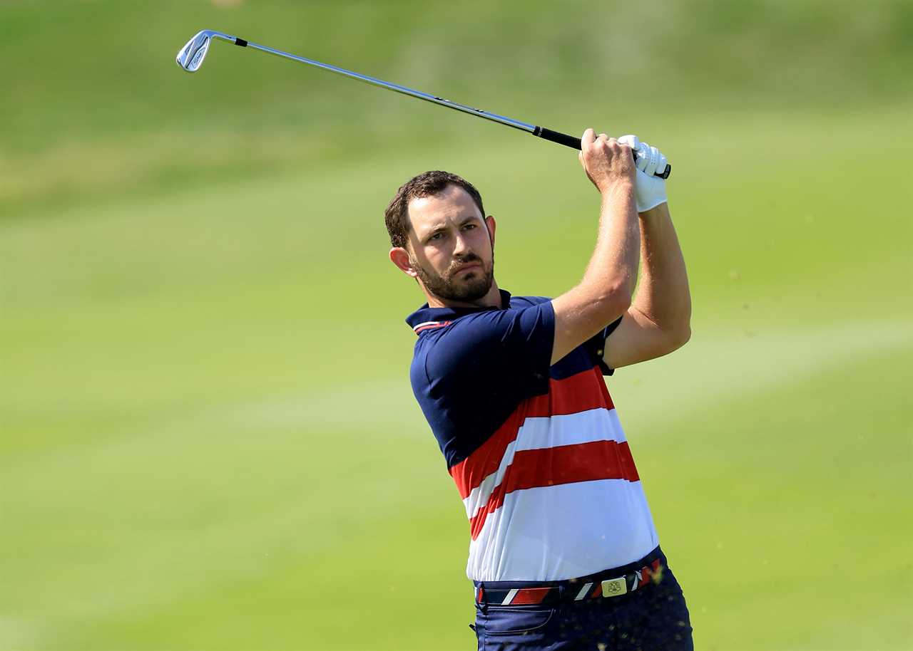 a man in an american flag shirt swings a golf club