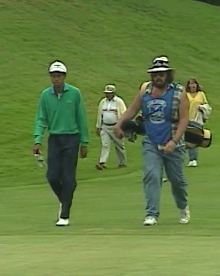 Tiger Woods walking during a junior amateur golf tournament.