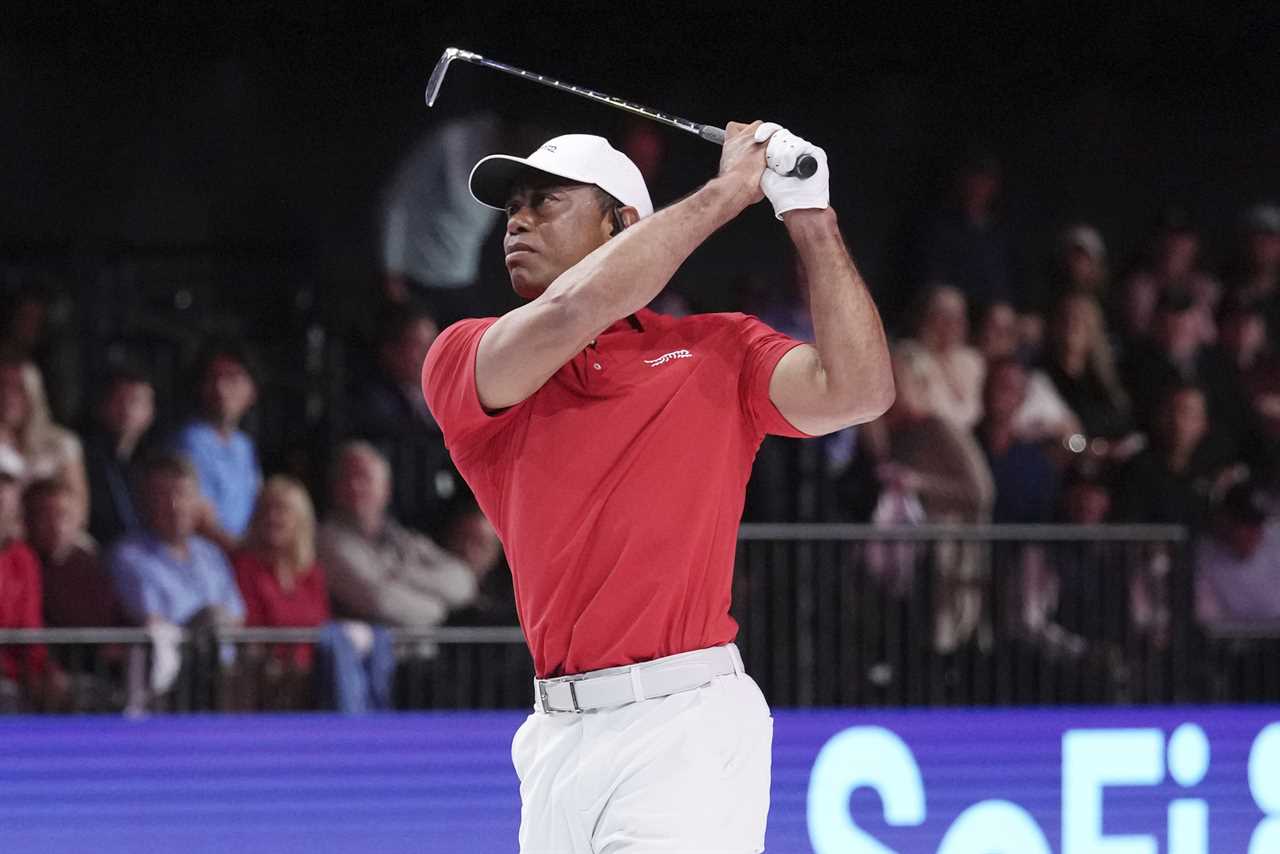 Tiger Woods teeing off during a golf match.