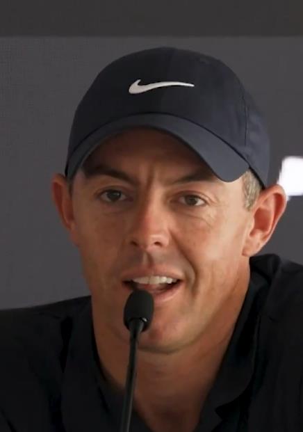 Rory McIlroy speaking into a microphone.