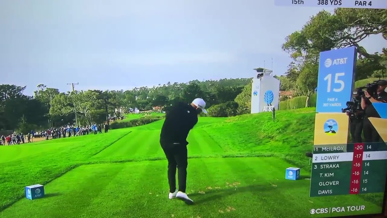 Golfer preparing to tee off on the 15th hole.