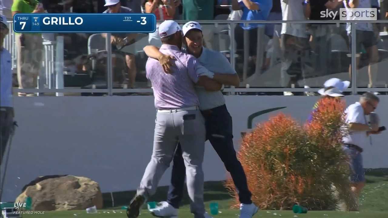 Two golfers embracing after a hole-in-one.