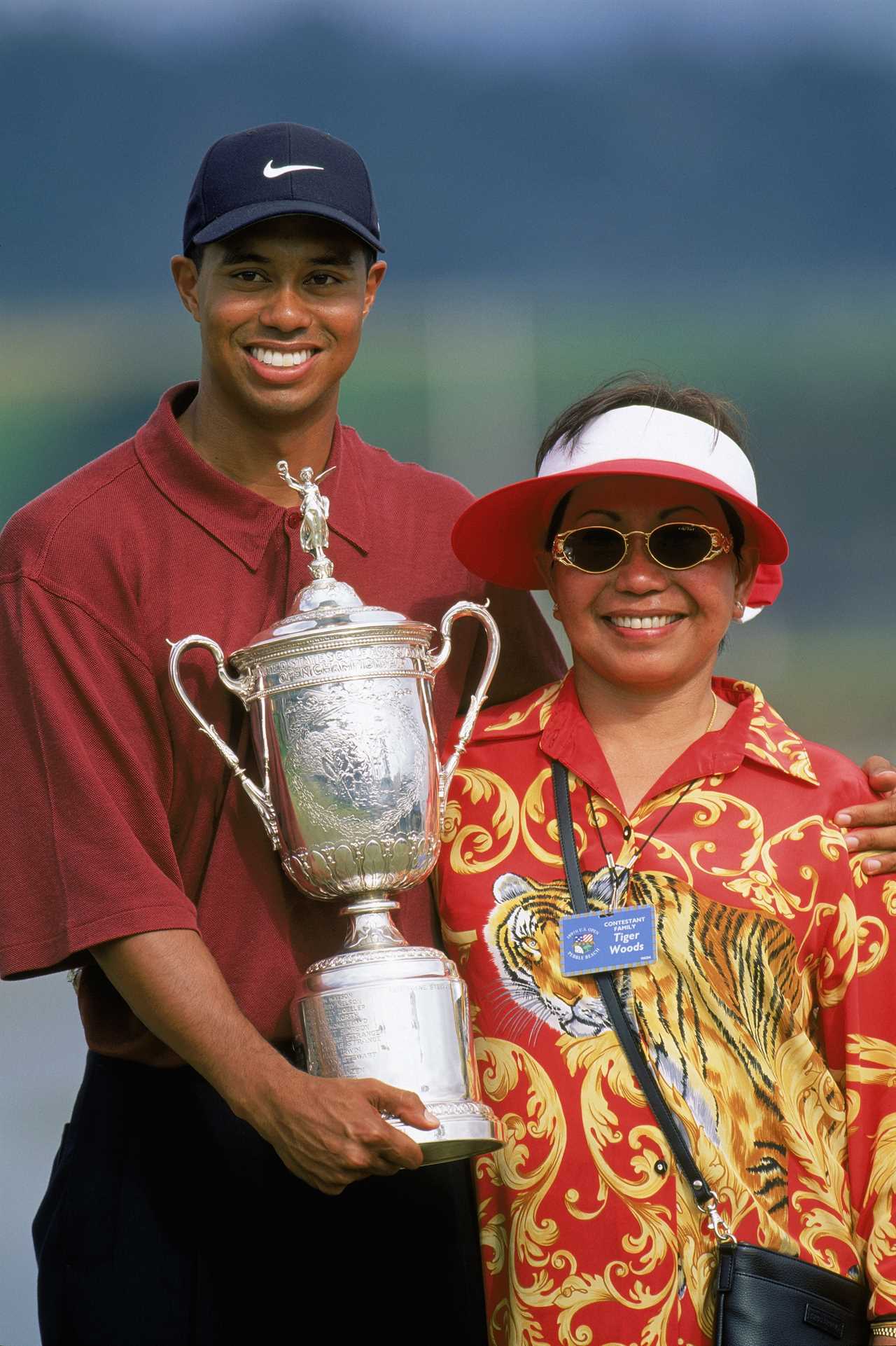 Tiger Woods holding the US Open trophy with his mother.