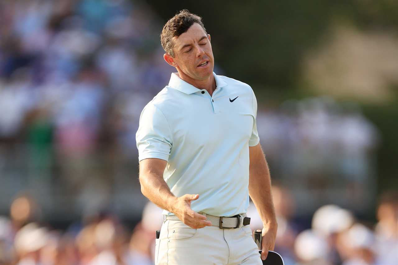 Rory McIlroy reacting after finishing a golf round.