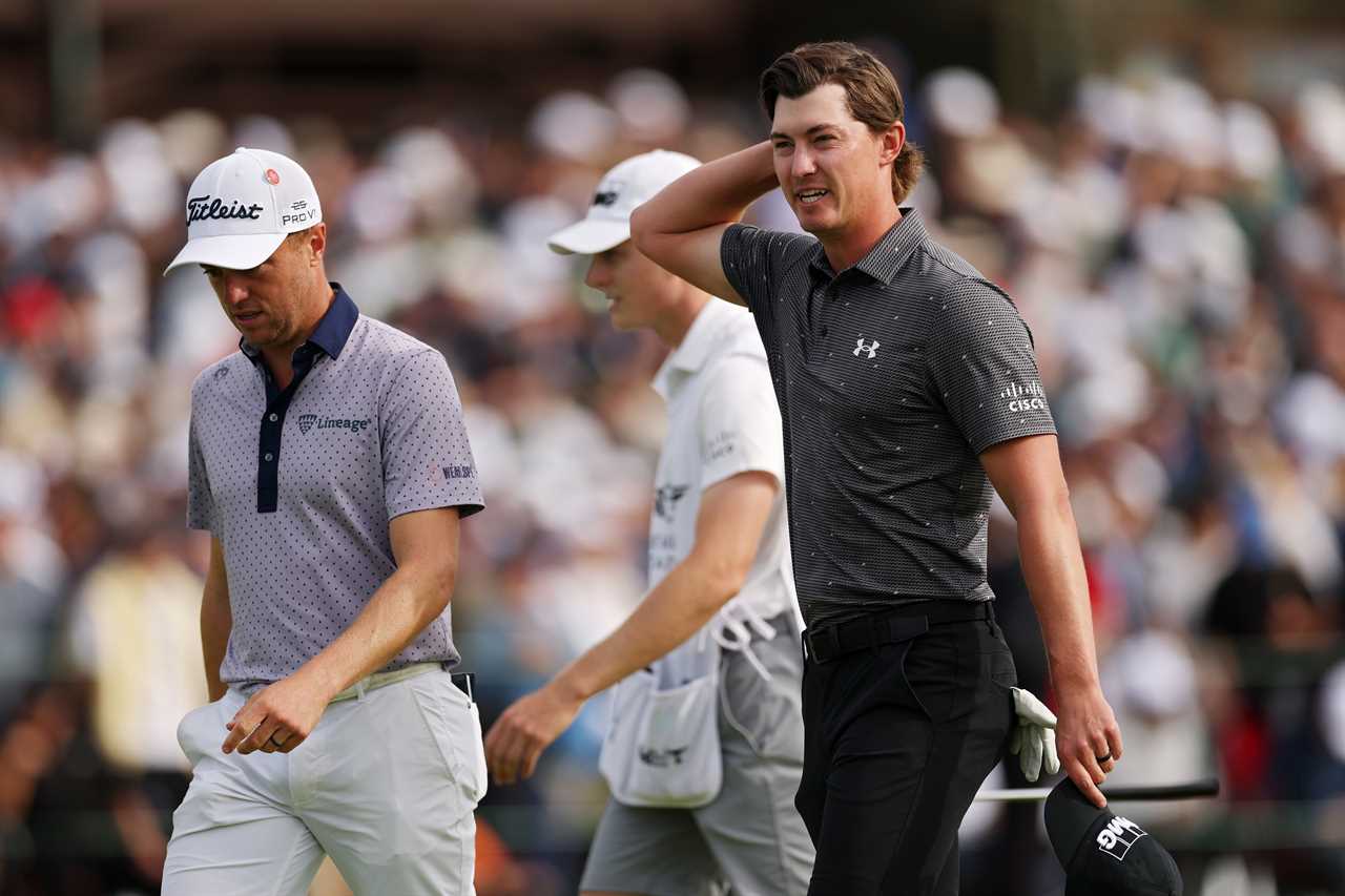 Justin Thomas and Maverick McNealy walking off the 18th green.