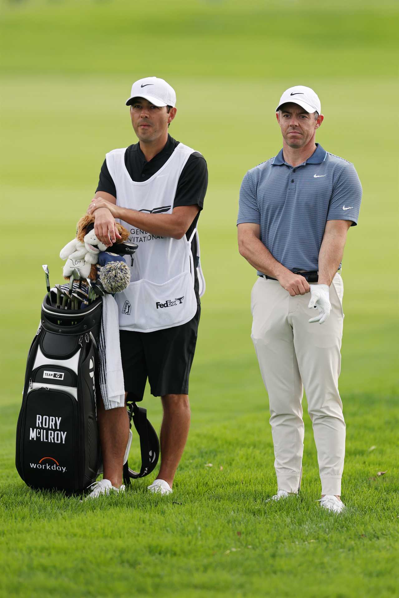 Rory McIlroy and his caddie on a golf course.