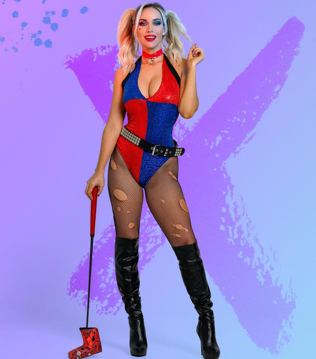 a woman in a harley quinn costume is holding a golf club