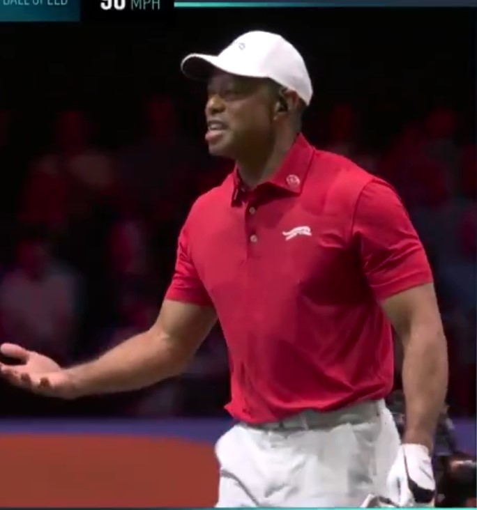 Man in red polo shirt gesturing.