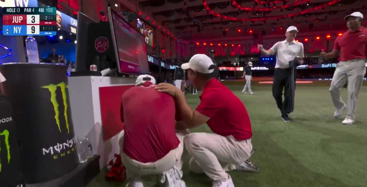 Two golfers comforting each other after a match.