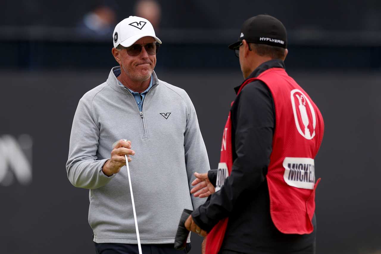 Phil Mickelson talking with his caddie.