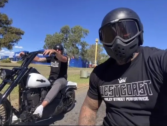 Two men on a Harley Davidson motorcycle.