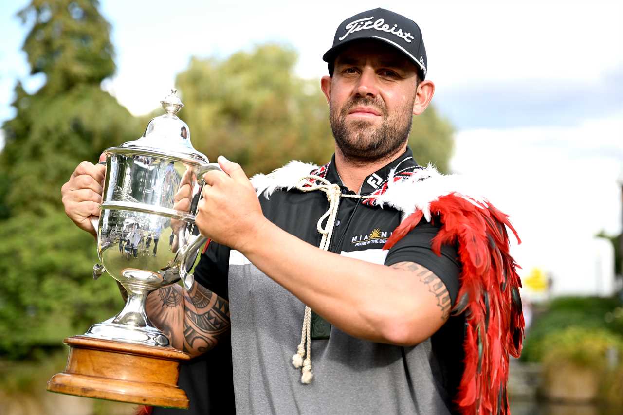 Ryan Peake of Australia celebrates winning the New Zealand Open, holding the trophy.