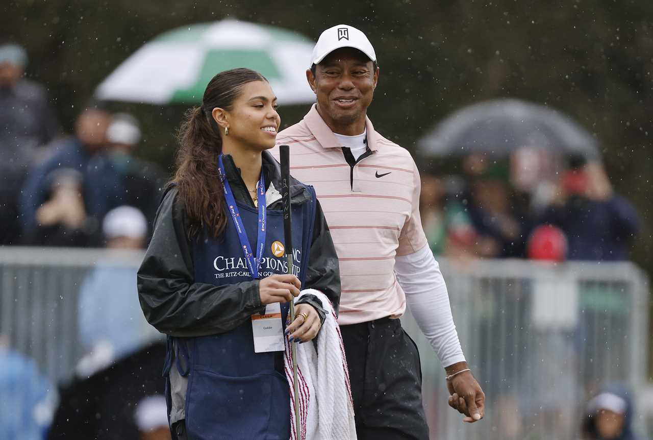 Tiger Woods and his daughter at a golf tournament.